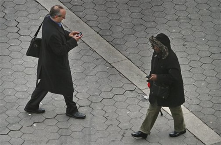 This Tuesday, Jan. 4, 2011 photo shows a pedestrian walking while using a phone in New York. While smartphones and other electronic devices changed popular culture by offering an ability to always stay connected, it so swiftly turned into such a compelling need that a simple walk down the street is considered wasted time. (AP Photo/Bebeto Matthews)